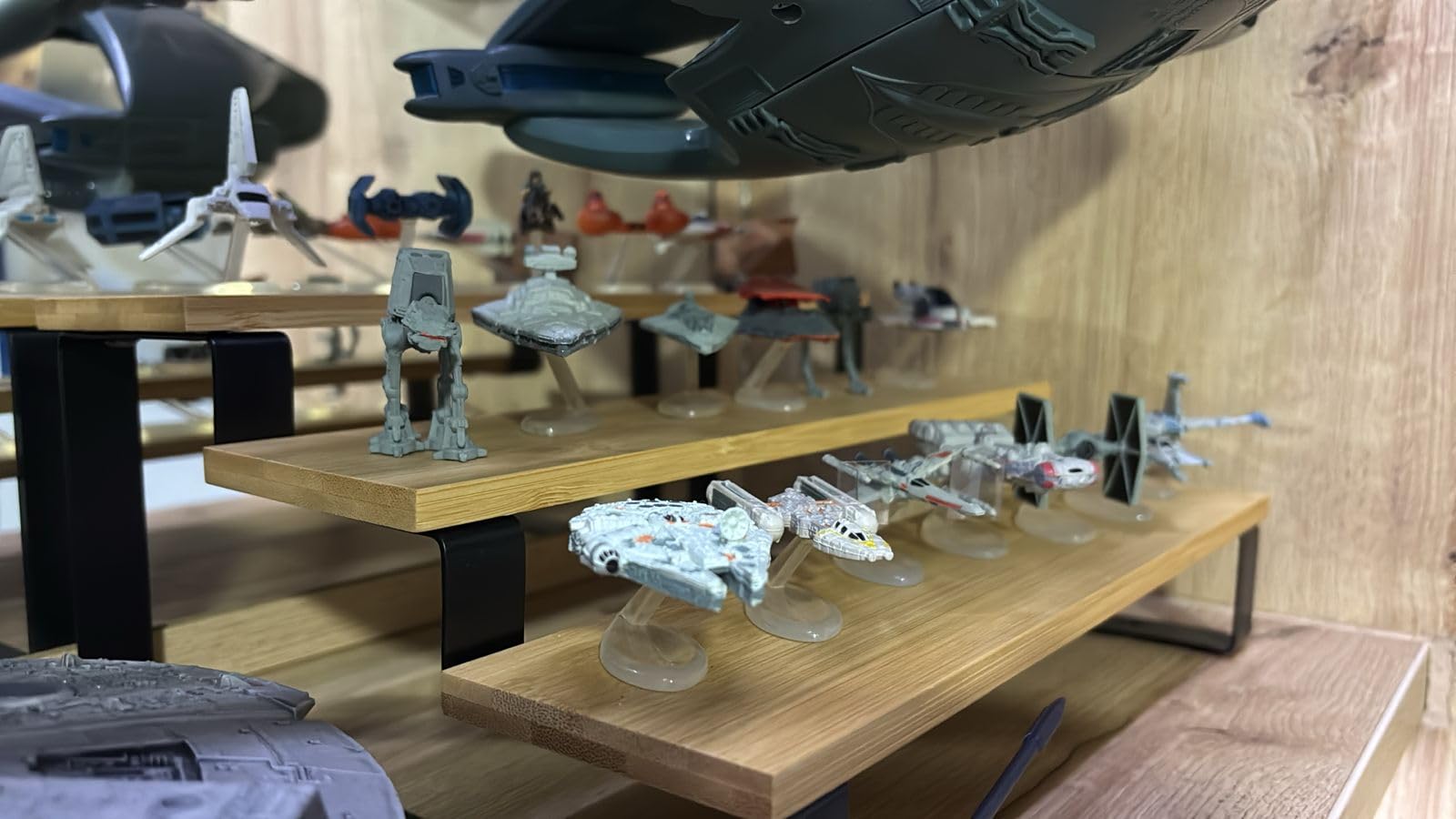 Customer photo of a Star Wars Micro Machines collection displayed on wooden shelf risers